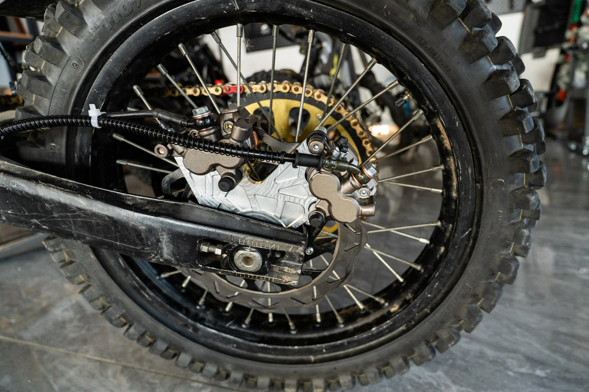 Rear foot brake conversion mounted to the Talaria Sting MX5 frame
